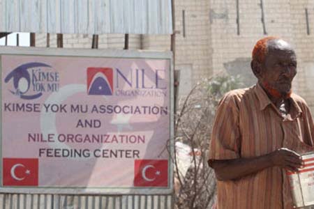 A displaced Somalian man walks away with food at a centre run by the Gulen-inspired Turkish aid agency Kimse Yok Mu in the Howlwadaag district of southern Mogadishu. Photograph: Feisal Omar/Reuters