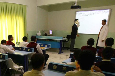 A student at one of the 30 Turkish schools in Iraq answers questions from his teacher in front of the board while other students follow. (Photo: Today's Zaman, Kürşat Bayhan)