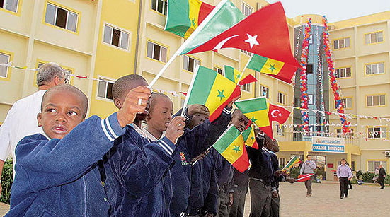 The Senegalese students are holding flags in front of their school (Photo: Sunday's Zaman)