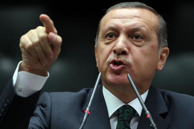 Turkish Prime Minister Tayyip Erdogan is applauded by members of parliament from his ruling Justice and Development Party (AKP) during a meeting at the Turkish parliament in Ankara June 25, 2013. (Adem Altan / AFP / Getty Images)