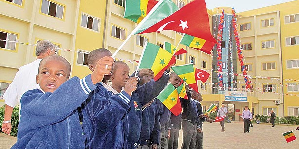 The Senegalese students are holding flags in front of their school (Photo: Sunday's Zaman)