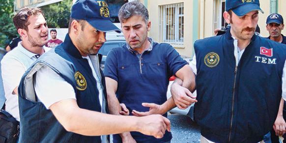 Police officer Tamer Özyılmaz, detained as part of a pre-dawn operation which included massive police arrests, is brought to Haseki Education and Research Hospital for a health screening. (Photo: Cihan, Kürşat Bayhan)