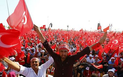 People wave national flags in Istanbul during the Democracy and Martyrs Rally organised by Turkish President Tayyip Erdogan and supported by the ruling AK Party, opposition Republican People’s Party and Nationalist Movement Party. Picture: REUTERS/UMIT BEKTAS