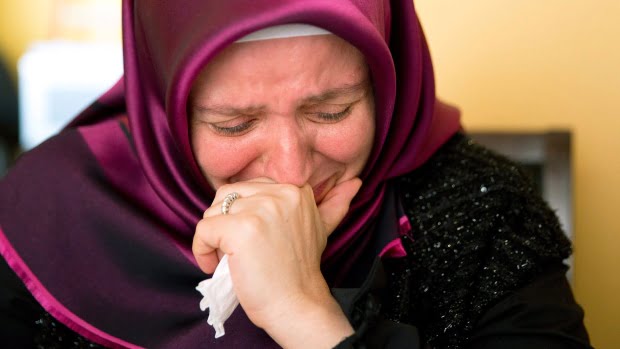 Rumeysa Hanci, wife of Calgary imam Davud Hanci who is imprisoned in Turkey, breaks down as she talks about her family's situation in Calgary. (Larry MacDougal/Canadian Press)