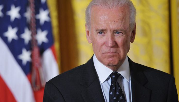 US Vice President Joe Biden watches as US President Barack Obama speaks during an event for the Council on Women and Girls in the East Room of the White House on January 22, 2014 in Washington, DC. AFP PHOTO/Mandel NGANMANDEL NGAN/AFP/Getty Images