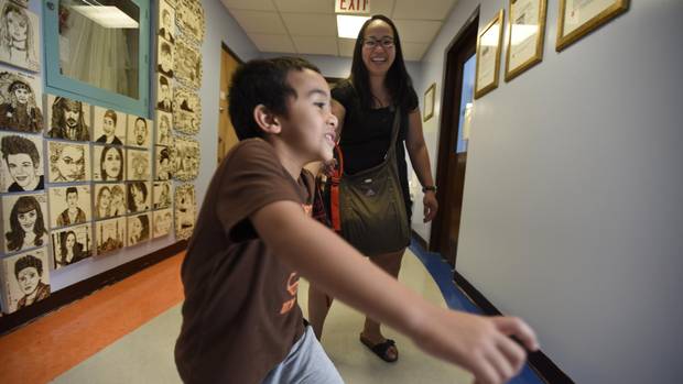 Kenan Guvercin, 5, and his mother, Maila Abenoja, leave the Nile Academy, a private Gulan school in Toronto which representatives of the Turkish government are trying to force to close.
(Fred Lum/The Globe and Mail)