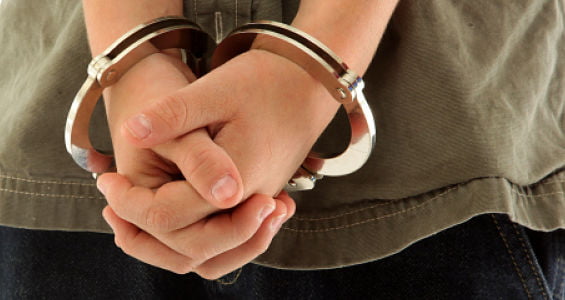 Child's hands handcuffed