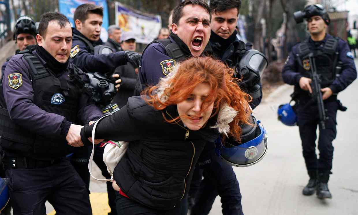  Riot police detain a demonstrator during a protest against the dismissal of academics from universities. Photograph: Umit Bektas/Reuters