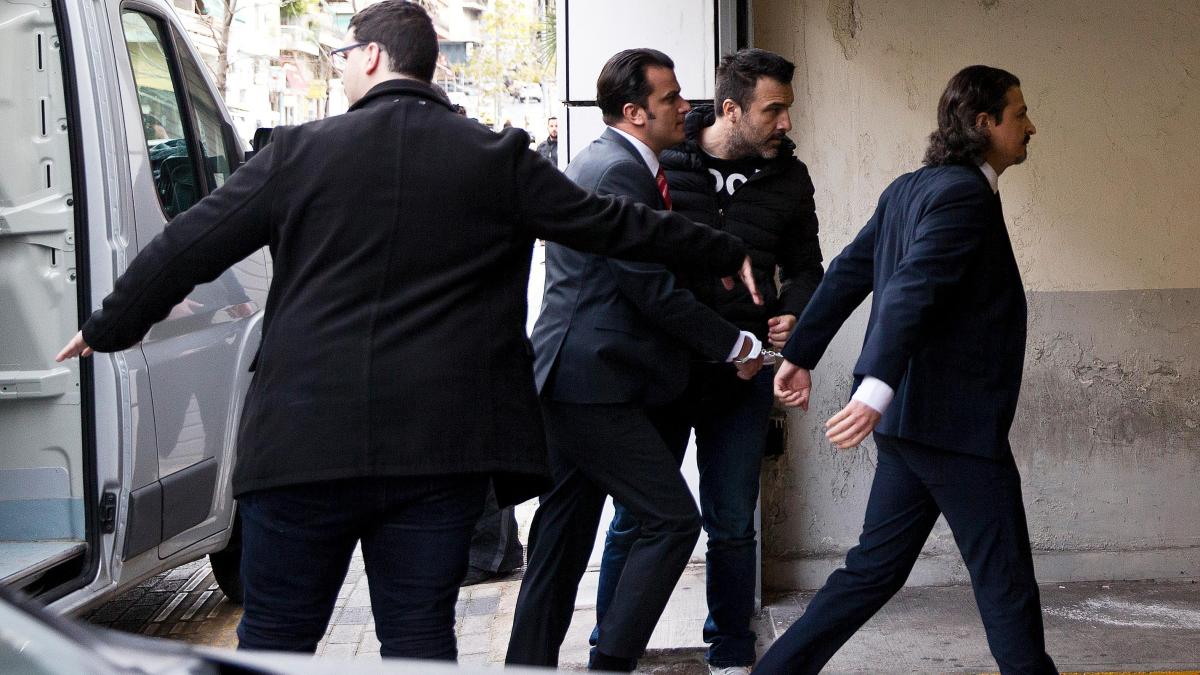 Two Turkish servicemen being taken in handcuffs to the Athens appeals court this morning. The court refused Turkey’s request to extradite them. 
PETROS GIANNAKOURIS/AP