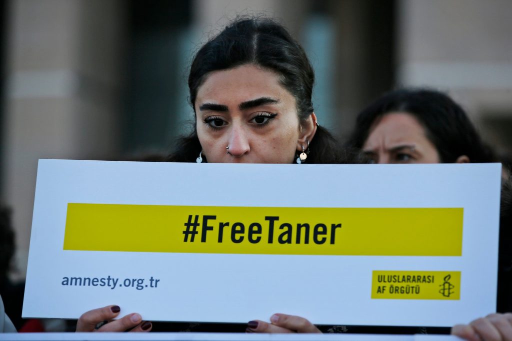 Human rights activists stage a protest, demanding the release of Amnesty's Turkey chairman Taner Kilic, imprisoned for alleged links to Gulen, in Istanbul. (AP)